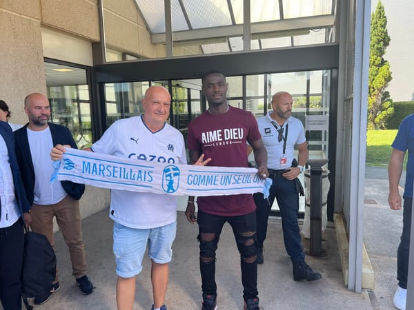 Eric Bailly pictured with a Marseille scarf as he completes a move to the French club from Manchester United