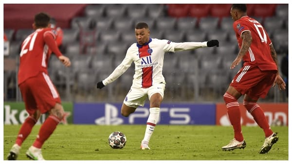 Kylian Mbappe aims a shot in front of the Bayern Munich goal